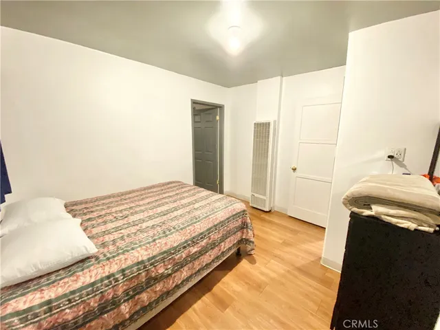 a bedroom with a bed and a mirror