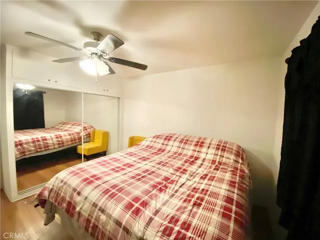 a bedroom with double bed and a chandelier