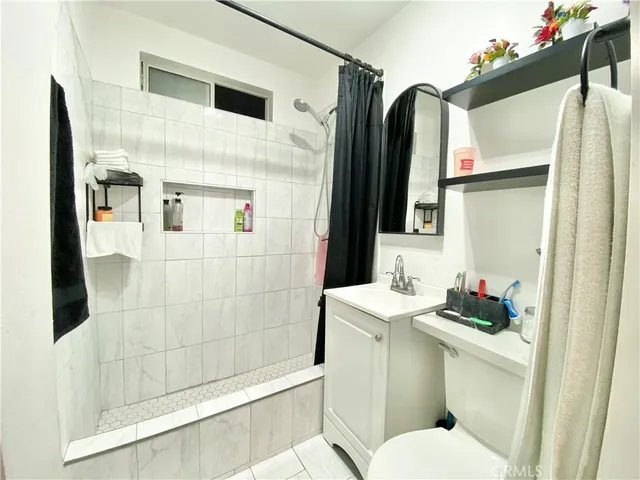a bathroom with a sink toilet and shower