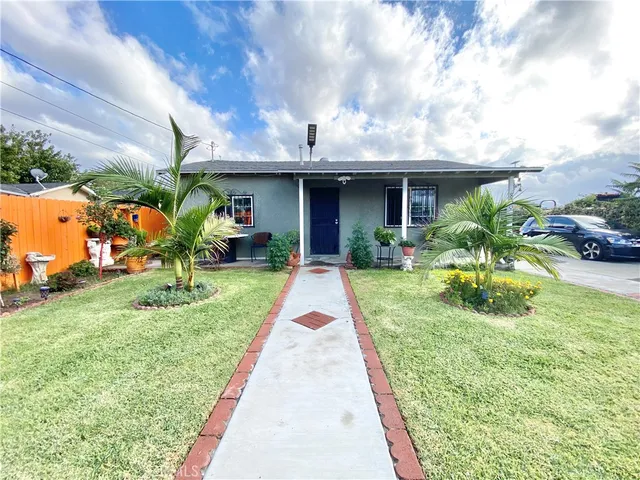 a view of house with yard and entertaining space