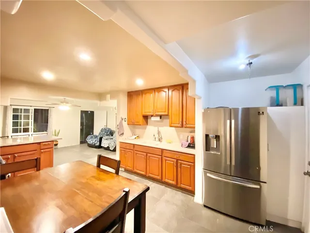 a kitchen with stainless steel appliances granite countertop a refrigerator and a stove top oven