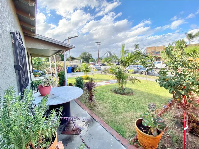 a view of a backyard with plants and a patio