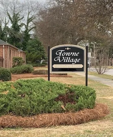 a view of a street sign under a white house