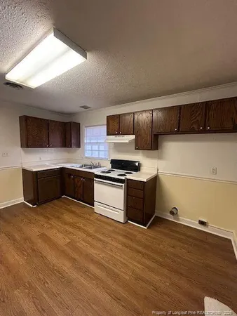 a kitchen with stainless steel appliances kitchen island granite countertop a stove a sink and a microwave