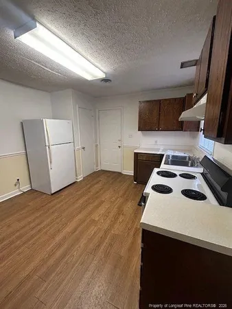 a bedroom with a bed and a white cabinets