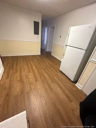 a view of a room with wooden floor