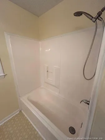 a bathroom with a bath tub and shower