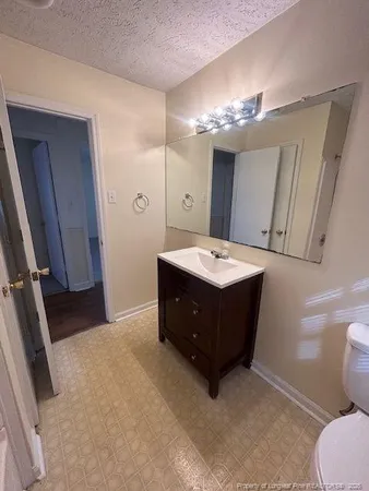a spacious bathroom with a double vanity sink and mirror