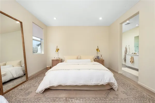 a spacious bedroom with a bed and a couch