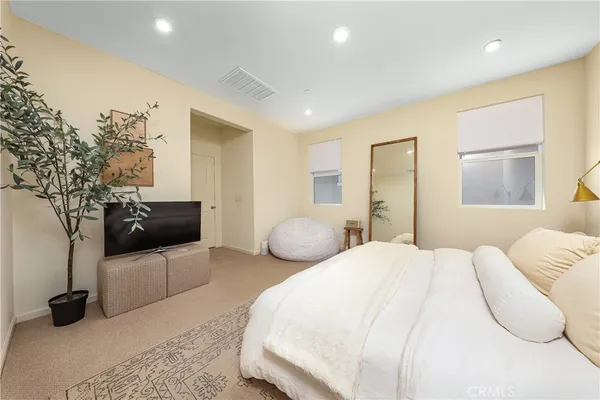 a bedroom with a bed and a couch