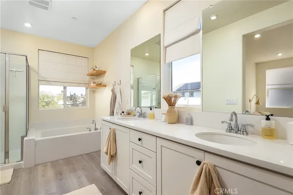 a bathroom with a granite countertop sink mirror and a bathtub