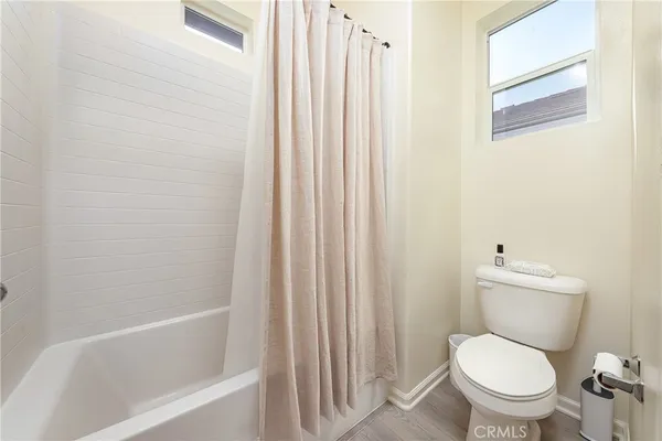 a white toilet sitting next to a bathtub