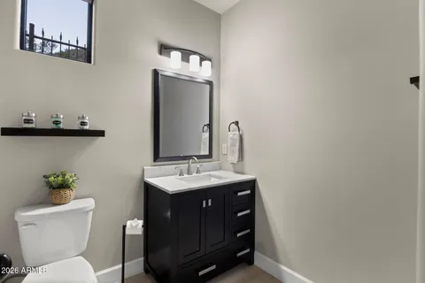 a bathroom with a toilet sink and mirror