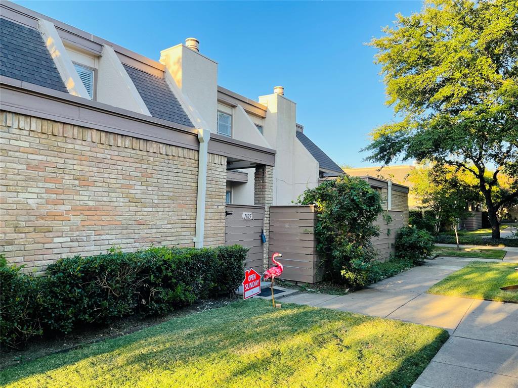 3121 Park Lane, Unit 1105 Dallas, TX 75220 - Photo 1 of 19 View of side of home featuring brick siding, a lawn, a chimney, and stucco siding