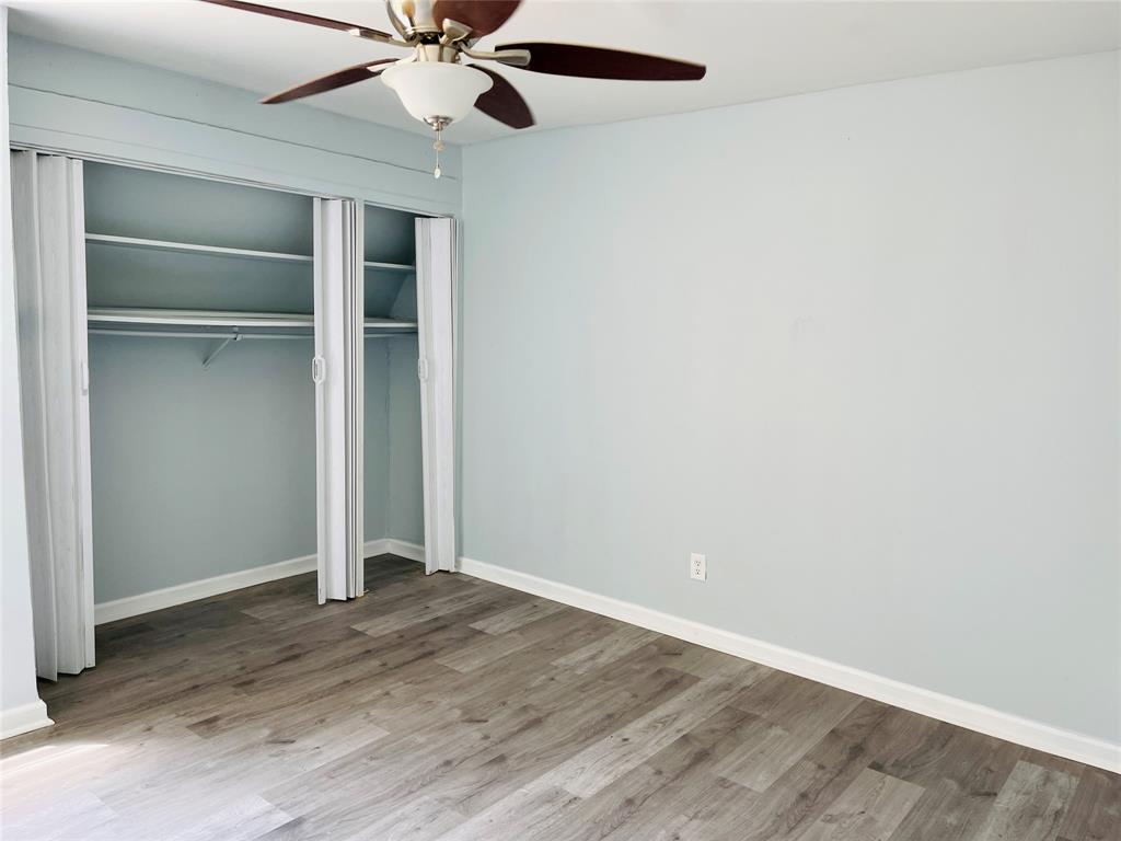 3121 Park Lane, Unit 1105 Dallas, TX 75220 - Photo 17 of 19 Unfurnished bedroom with wood finished floors and a ceiling fan