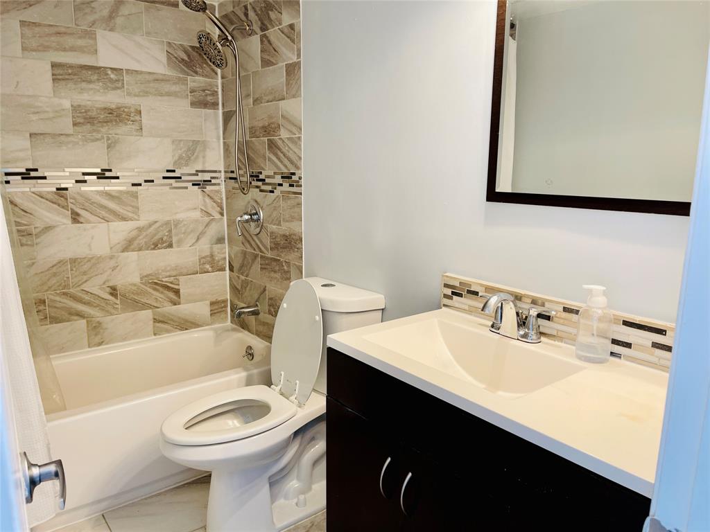 3121 Park Lane, Unit 1105 Dallas, TX 75220 - Photo 18 of 19 Bathroom with shower / bathtub combination with curtain, tasteful backsplash, and vanity