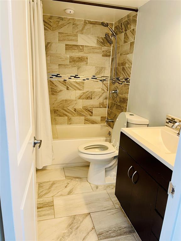 3121 Park Lane, Unit 1105 Dallas, TX 75220 - Photo 19 of 19 Bathroom featuring shower / bath combination with curtain, vanity, and marble finish flooring