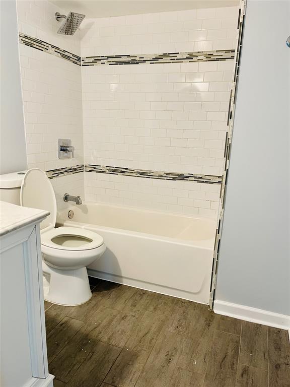 3121 Park Lane, Unit 1105 Dallas, TX 75220 - Photo 10 of 19 Full bathroom with wood finished floors, shower combination, and vanity