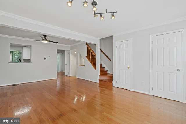 a view of an entryway with wooden floor and windows