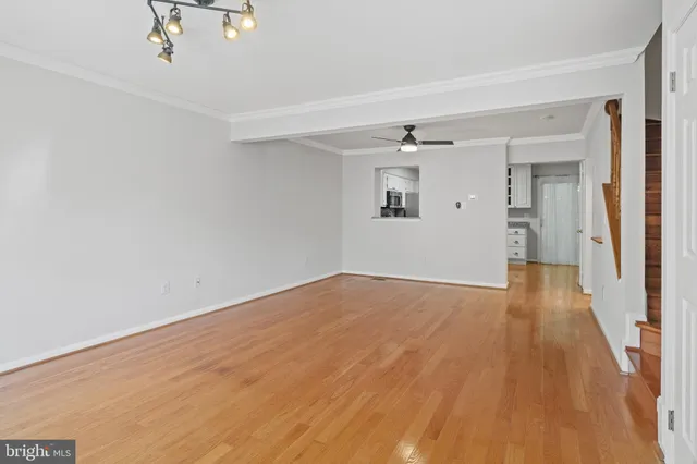 a view of empty room with wooden floor