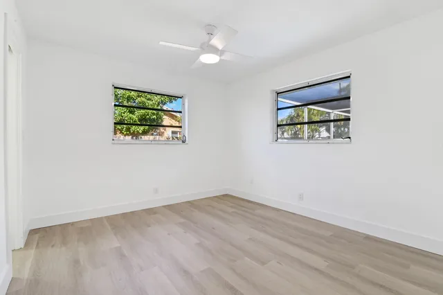 wooden floor in an empty room with a window