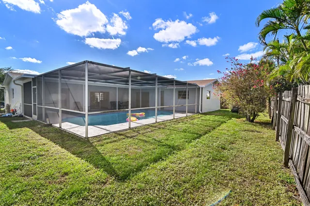 a view of an house with backyard space and garden