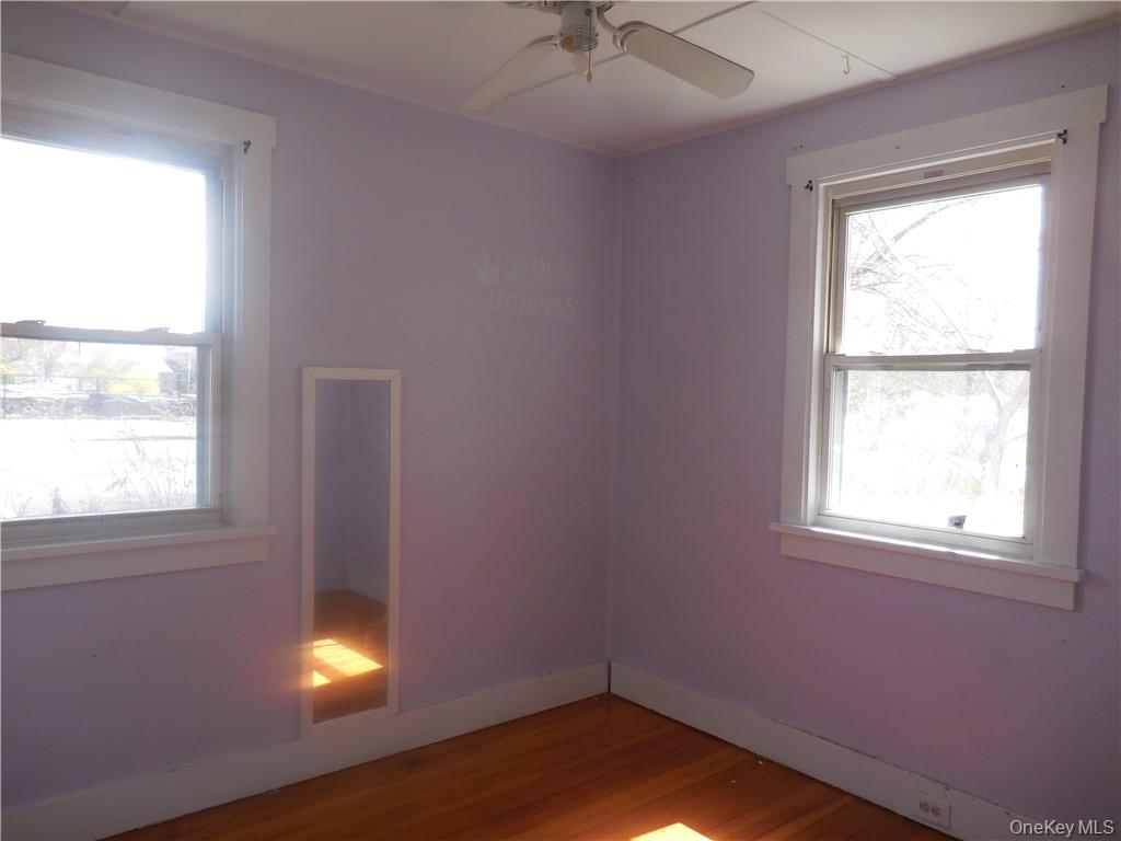 10 Edmunds Lane, Unit A Pine Bush, NY 12566 - Photo 15 of 23 an empty room with a window and wooden floor