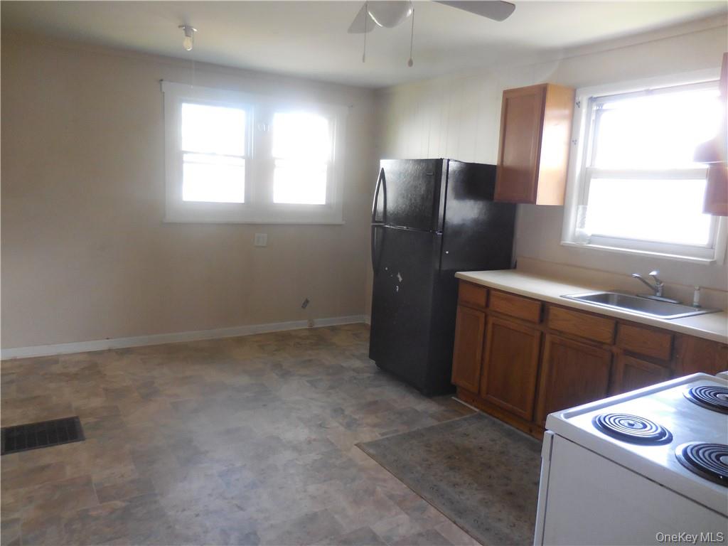 10 Edmunds Lane, Unit A Pine Bush, NY 12566 - Photo 7 of 23 a kitchen with a refrigerator and window