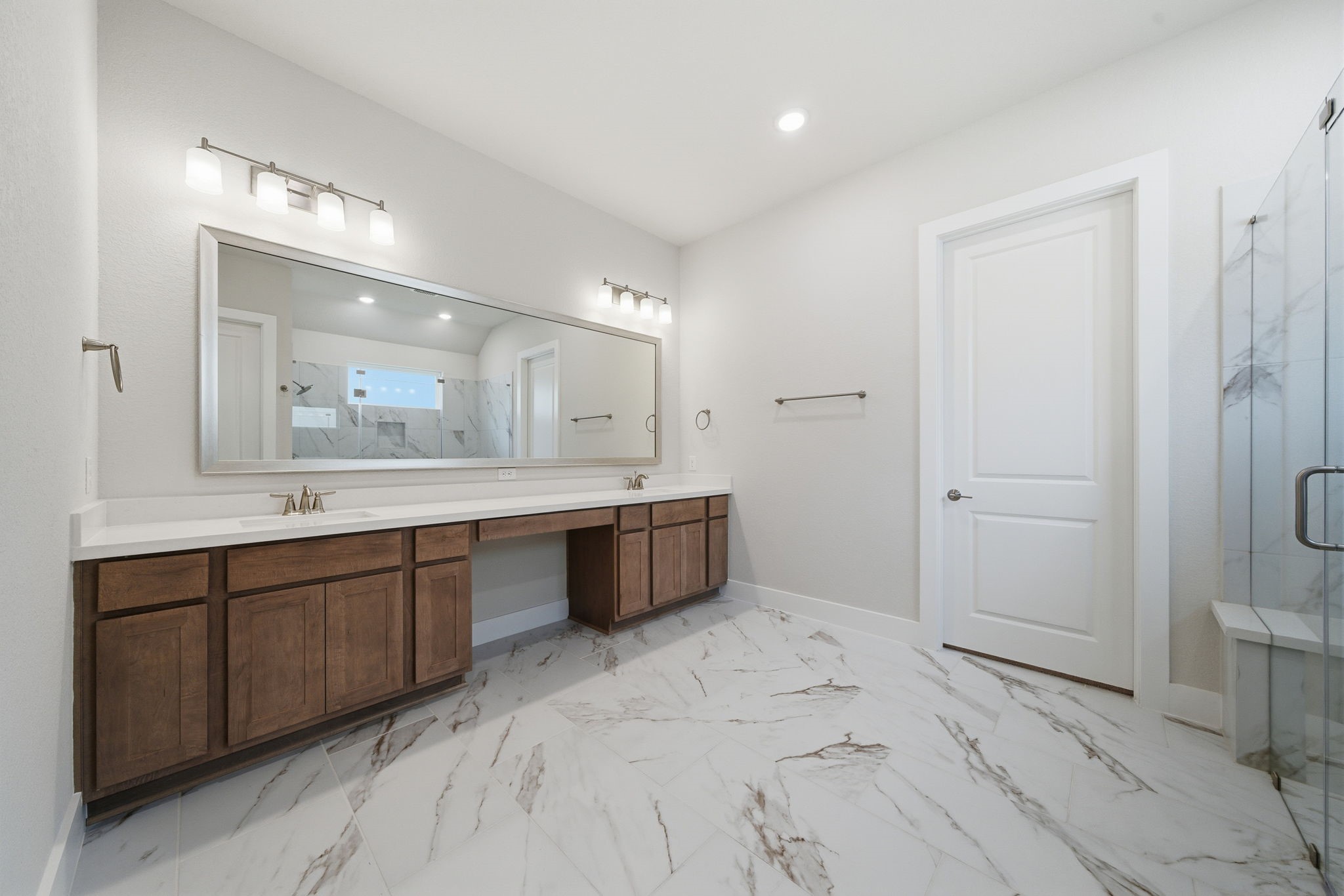 10026 Larkin Cove Willis, TX 77318 - Photo 26 of 46 a spacious bathroom with a double vanity sink a mirror and a bathtub