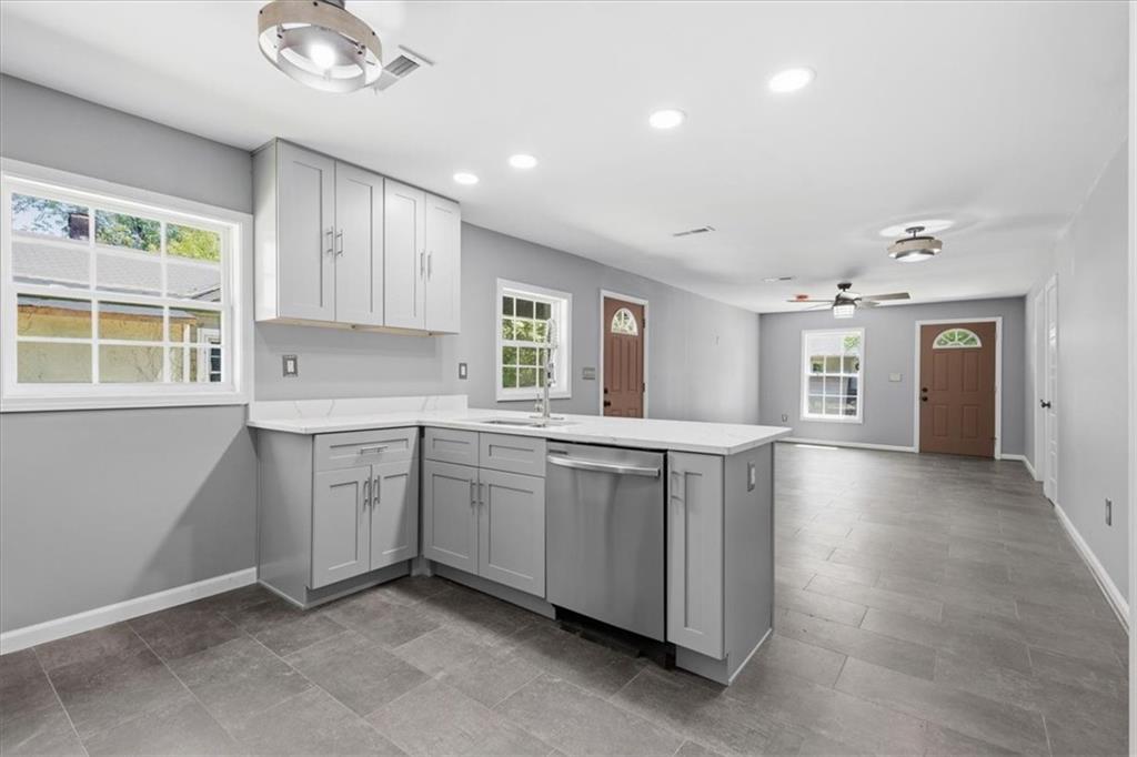409 Calhoun Avenue Northeast Rome, GA 30161 - Photo 11 of 25 a kitchen with granite countertop a sink cabinets and window