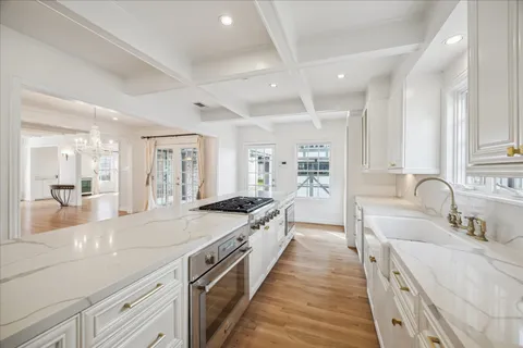a large kitchen with kitchen island a sink a counter space and stainless steel appliances