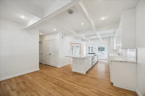 a view of kitchen and hall with wooden floor