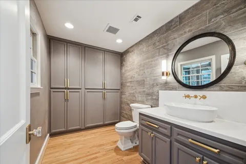 a bathroom with a toilet a sink and a mirror