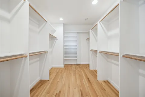 a view of walk in closet with empty racks