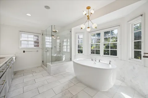 a large spacious bathroom with a tub shower and sink