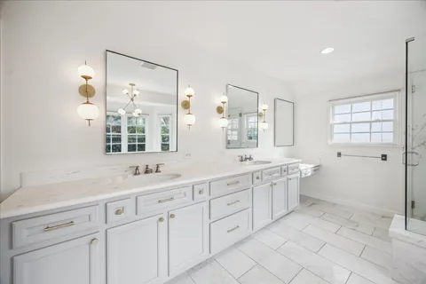 a spacious bathroom with a granite countertop sink mirror and a