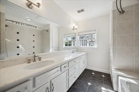 a bathroom with a double vanity sink mirror and double