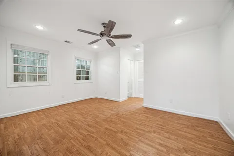 wooden floor in an empty room with a window