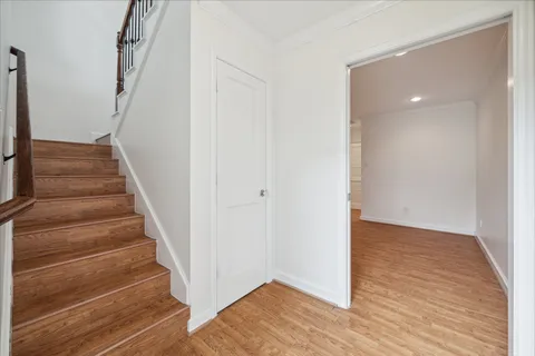 a view of an entryway with wooden floor
