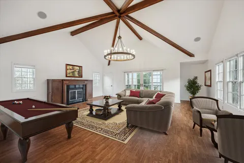 a living room with furniture a fireplace and a large window