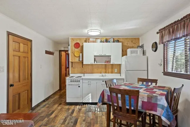 a view of a dining room with furniture and window