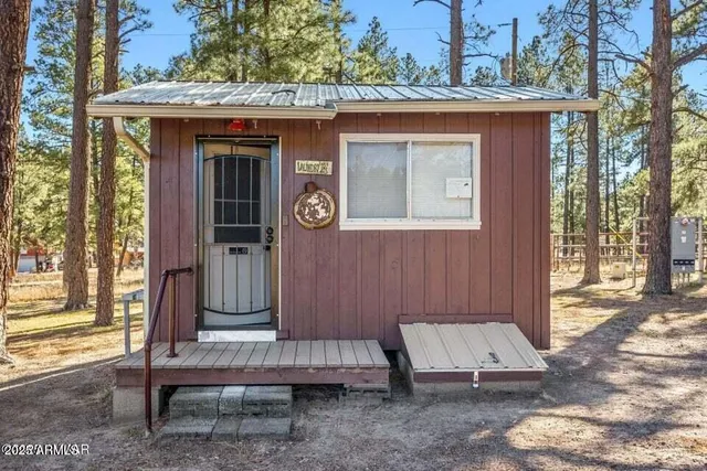 a view of backyard with deck and outdoor seating