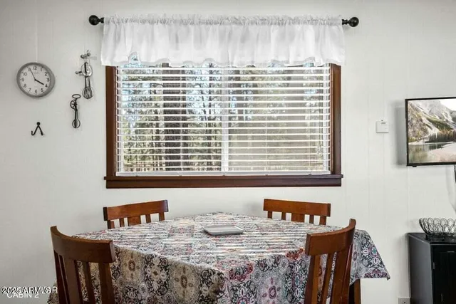 a view of a dining room with a table and chairs