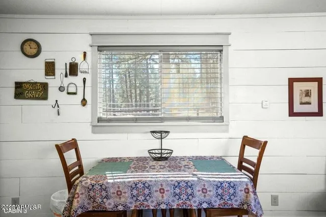 a living room with fireplace furniture and a large window