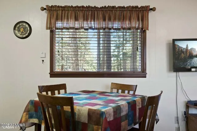 a view of a dining room with furniture and a window