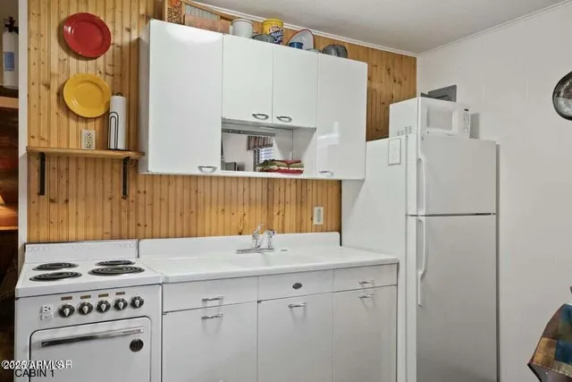 a kitchen with stainless steel appliances granite countertop a sink and a stove