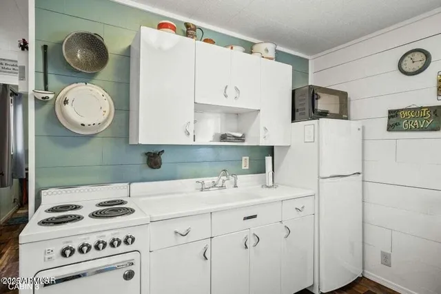 a kitchen with a stove and a white refrigerator