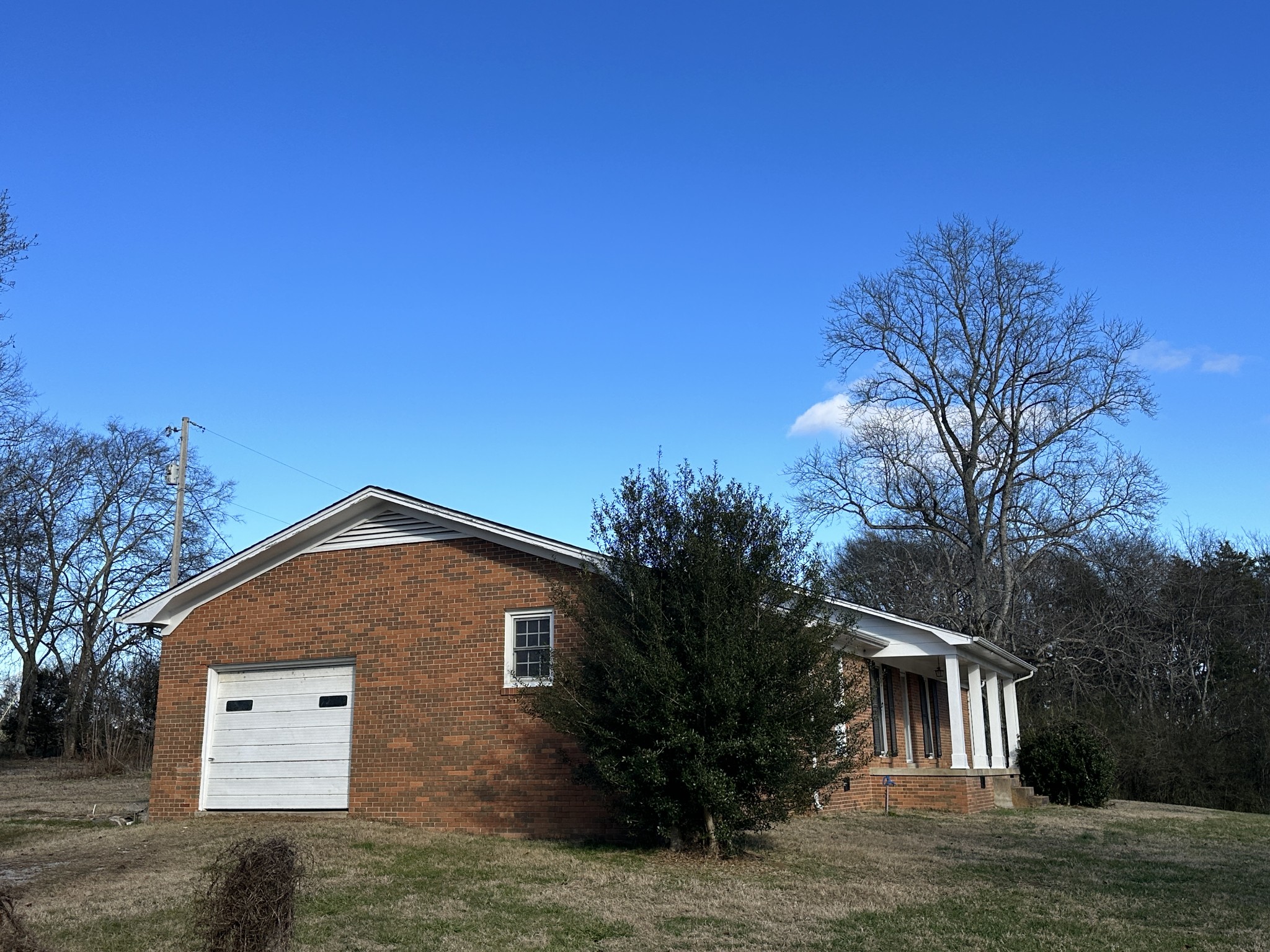 650 Petty Road Pulaski, TN 38478 - Photo 3 of 19 a front view of a house with a garden
