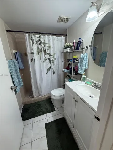 a bed room with a bed and a television