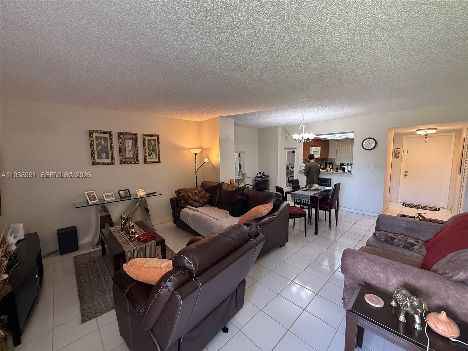 12209 Southwest 14th Lane, Unit 1101 Miami, FL 33184 - Photo 3 of 18 a living room with furniture and a flat screen tv